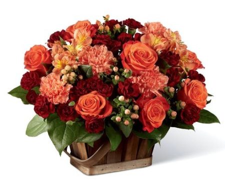 Orange roses have a truly charming look surrounded by orange carnations, orange Peruvian Lilies, and peach hypericum berries, offset by burgundy mini carnations and lush greens for an enchanting affect. Presented in a rectangular stained woodchip basket