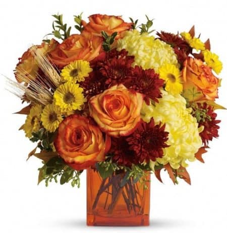 Rich fall hues are on brilliant display in this beautiful arrangement that comes delivered in a classic cube vase.